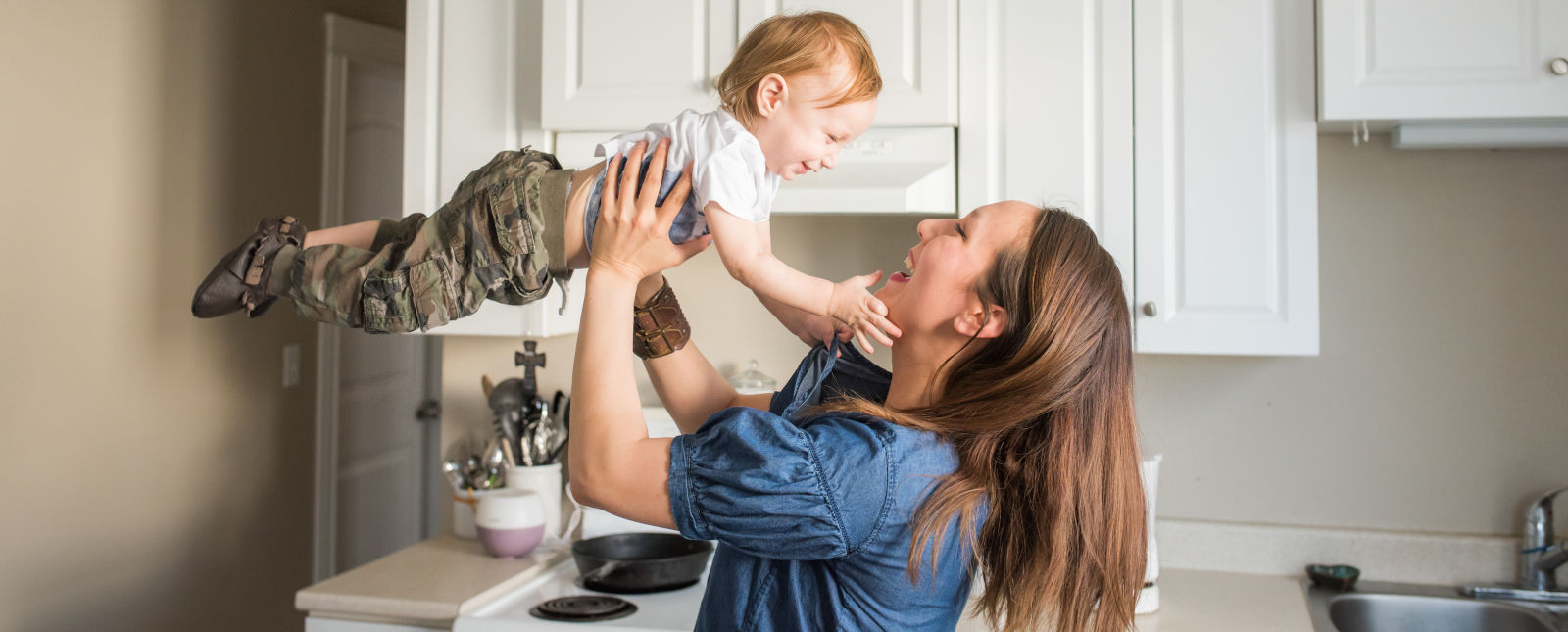 photo of woman playing with a young child